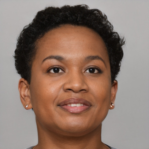 Joyful black young-adult female with short  brown hair and brown eyes