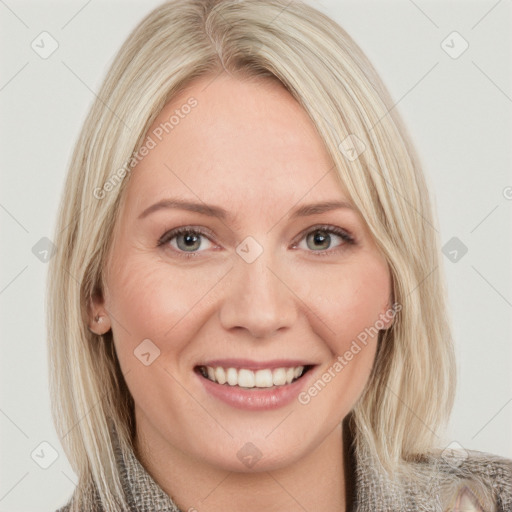 Joyful white young-adult female with long  blond hair and blue eyes