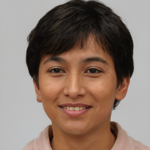 Joyful asian adult female with short  brown hair and brown eyes