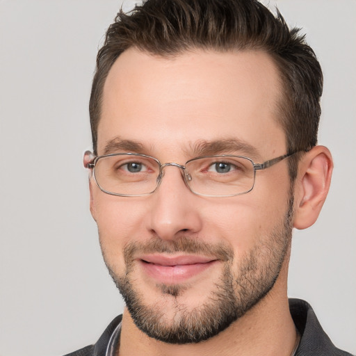 Joyful white adult male with short  brown hair and brown eyes