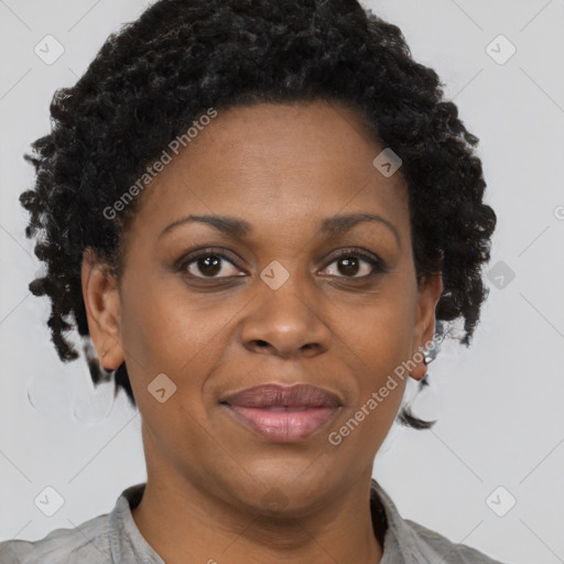 Joyful black adult female with short  brown hair and brown eyes