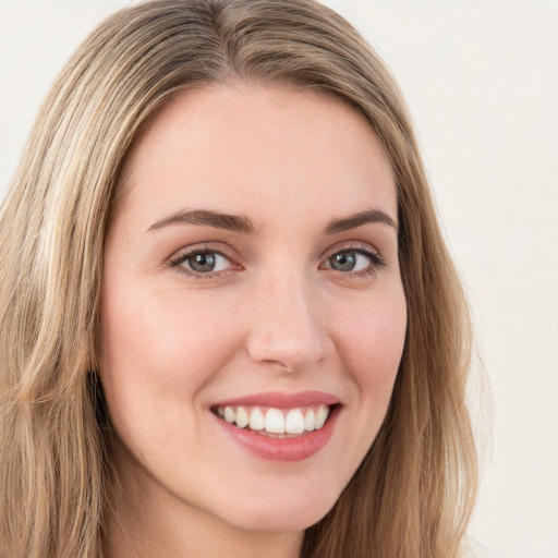 Joyful white young-adult female with long  brown hair and green eyes