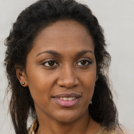 Joyful black adult female with medium  brown hair and brown eyes