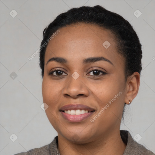 Joyful black young-adult female with short  black hair and brown eyes