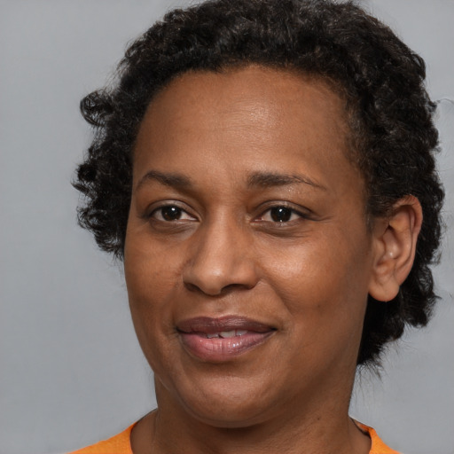 Joyful black adult female with short  brown hair and brown eyes