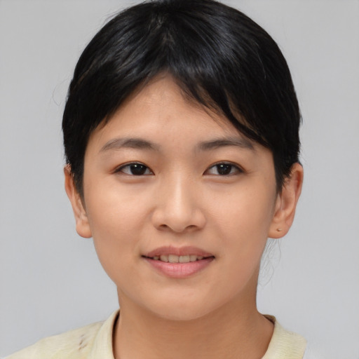 Joyful asian young-adult female with short  brown hair and brown eyes