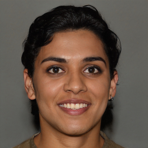 Joyful latino young-adult female with short  brown hair and brown eyes