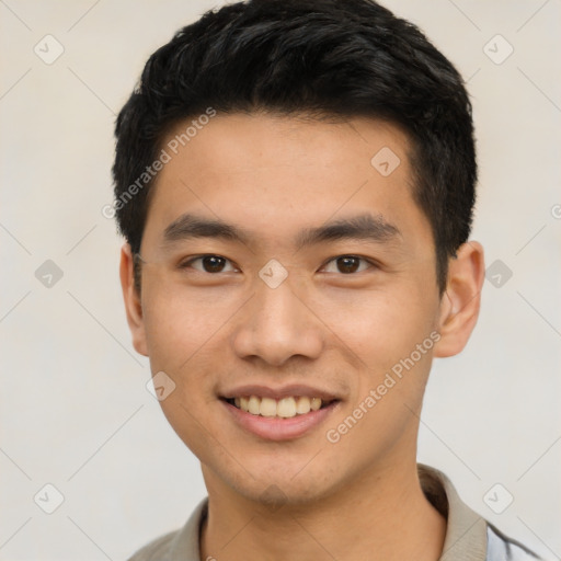 Joyful asian young-adult male with short  black hair and brown eyes