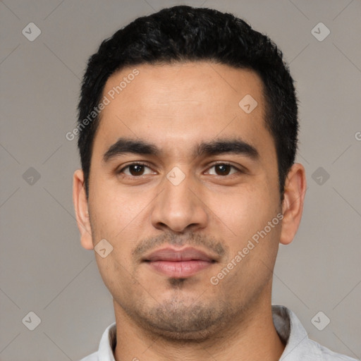 Joyful latino young-adult male with short  black hair and brown eyes