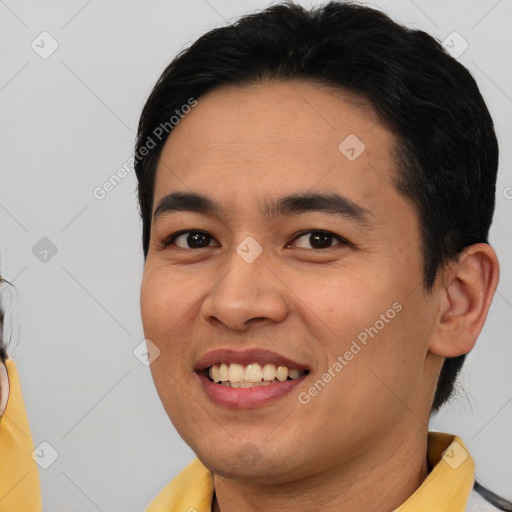 Joyful white young-adult male with short  black hair and brown eyes