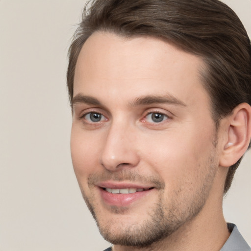 Joyful white young-adult male with short  brown hair and brown eyes