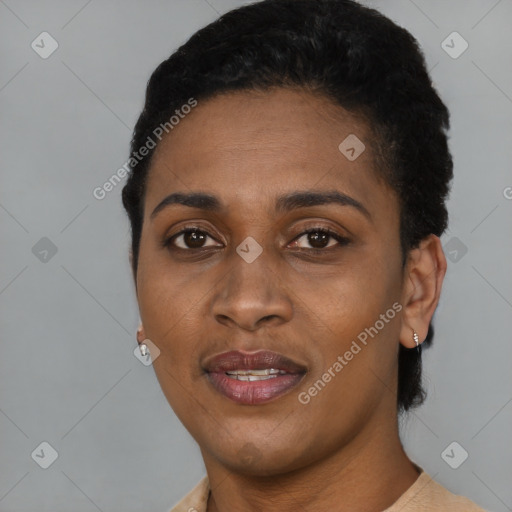 Joyful black young-adult female with short  black hair and brown eyes