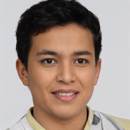 Joyful latino young-adult male with short  brown hair and brown eyes