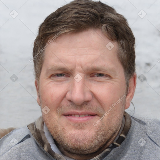 Joyful white adult male with short  brown hair and grey eyes