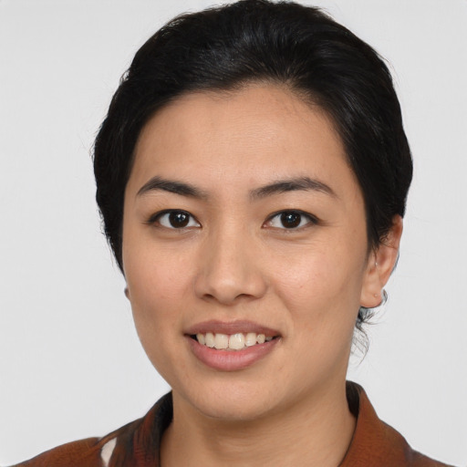 Joyful asian young-adult female with medium  brown hair and brown eyes