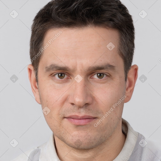 Joyful white adult male with short  brown hair and brown eyes