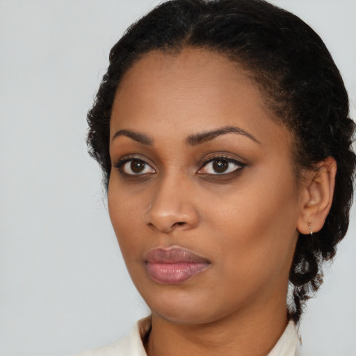 Neutral black young-adult female with medium  brown hair and brown eyes