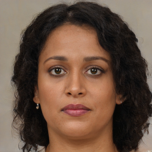 Neutral black young-adult female with long  brown hair and brown eyes