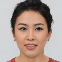 Joyful asian young-adult female with medium  brown hair and brown eyes