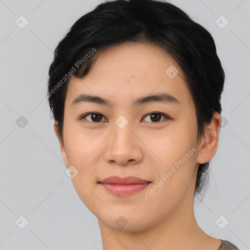 Joyful asian young-adult female with short  black hair and brown eyes