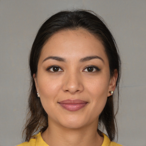 Joyful latino young-adult female with medium  brown hair and brown eyes