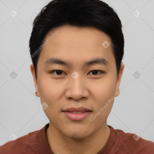 Joyful asian young-adult male with short  black hair and brown eyes