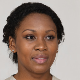 Joyful black adult female with medium  brown hair and brown eyes