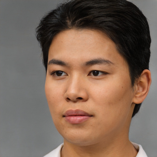 Joyful asian young-adult female with short  brown hair and brown eyes