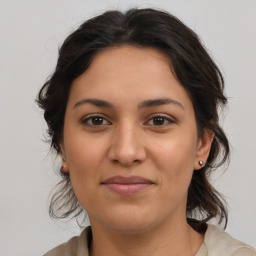 Joyful latino young-adult female with medium  brown hair and brown eyes