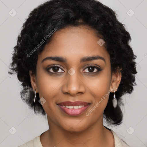 Joyful black young-adult female with long  black hair and brown eyes