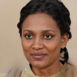 Joyful black adult female with short  brown hair and brown eyes