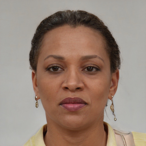 Joyful black adult female with short  brown hair and brown eyes