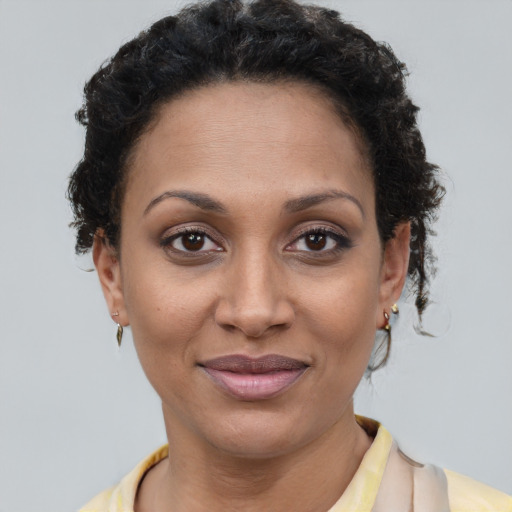 Joyful latino young-adult female with short  brown hair and brown eyes