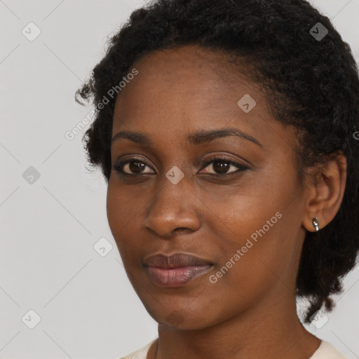 Neutral black young-adult female with medium  brown hair and brown eyes