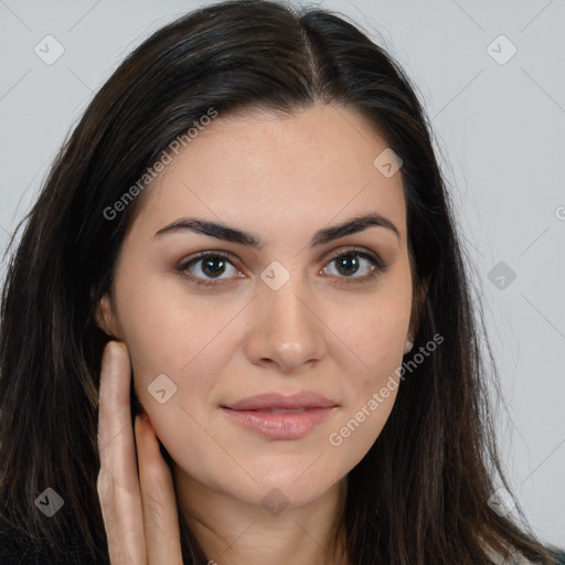 Joyful white young-adult female with long  brown hair and brown eyes