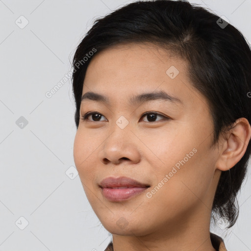 Joyful asian young-adult female with short  brown hair and brown eyes