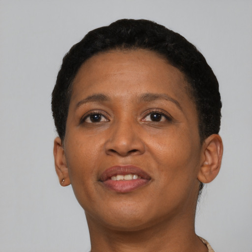 Joyful black adult female with short  brown hair and brown eyes