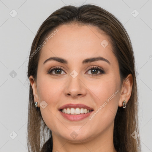 Joyful white young-adult female with long  brown hair and brown eyes