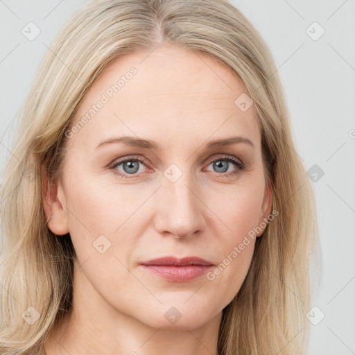 Joyful white young-adult female with long  brown hair and blue eyes