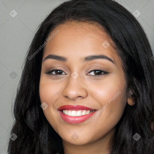 Joyful latino young-adult female with long  black hair and brown eyes