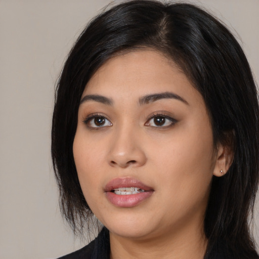 Joyful latino young-adult female with medium  black hair and brown eyes