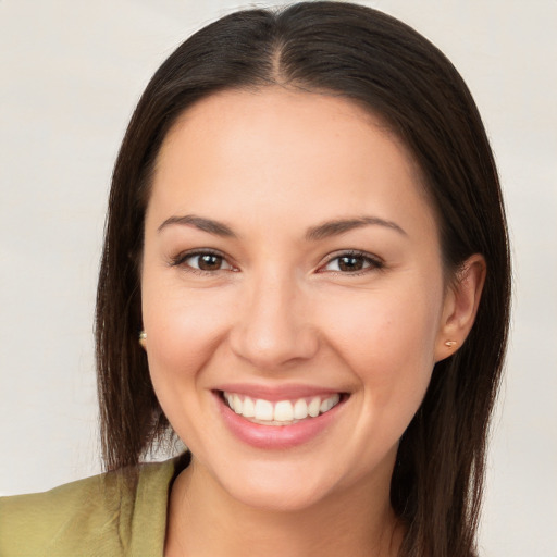 Joyful white young-adult female with long  brown hair and brown eyes