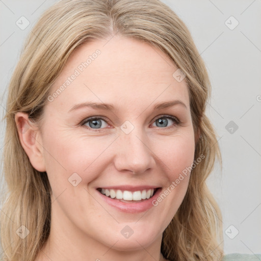 Joyful white young-adult female with long  brown hair and blue eyes