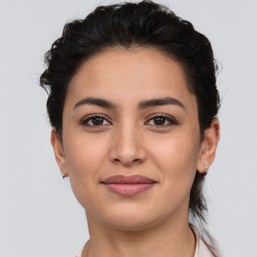 Joyful latino young-adult female with short  brown hair and brown eyes