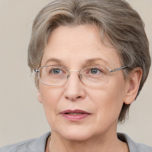 Joyful white middle-aged female with short  brown hair and blue eyes