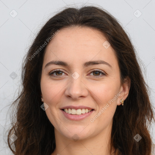 Joyful white adult female with long  brown hair and brown eyes