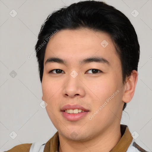 Joyful asian young-adult male with short  black hair and brown eyes