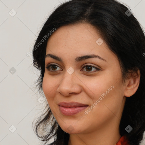 Joyful latino young-adult female with long  brown hair and brown eyes