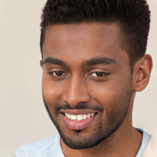 Joyful black young-adult male with short  brown hair and brown eyes