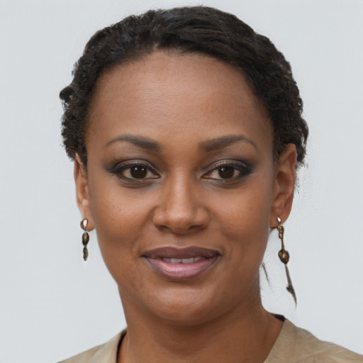 Joyful black adult female with short  brown hair and brown eyes
